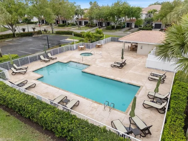Pool featuring a residential view, a patio, fence private yard, and a hot tub