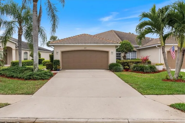 View of front of home with stucco siding, an attached garage, and a tile roof
