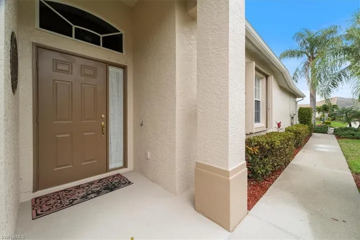 View of exterior entry featuring stucco siding