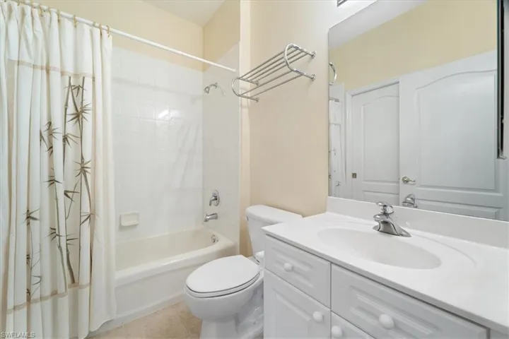 Full bathroom featuring vanity, tile patterned floors, toilet, and shower / bath combo