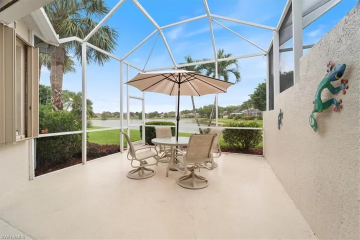 Sunroom featuring a water view