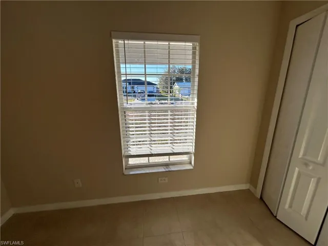 Unfurnished bedroom featuring a closet and light tile patterned floors
