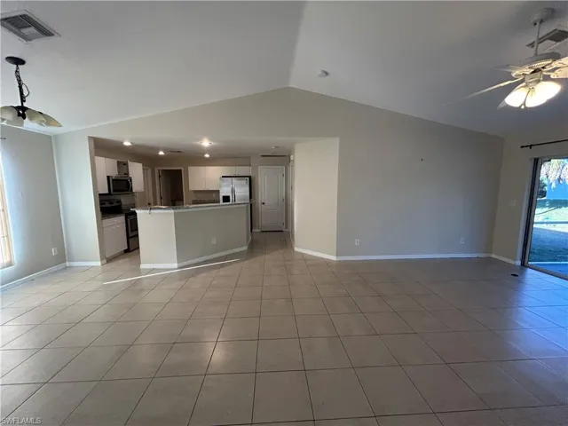 Unfurnished living room featuring a ceiling fan and light tile patterned floors