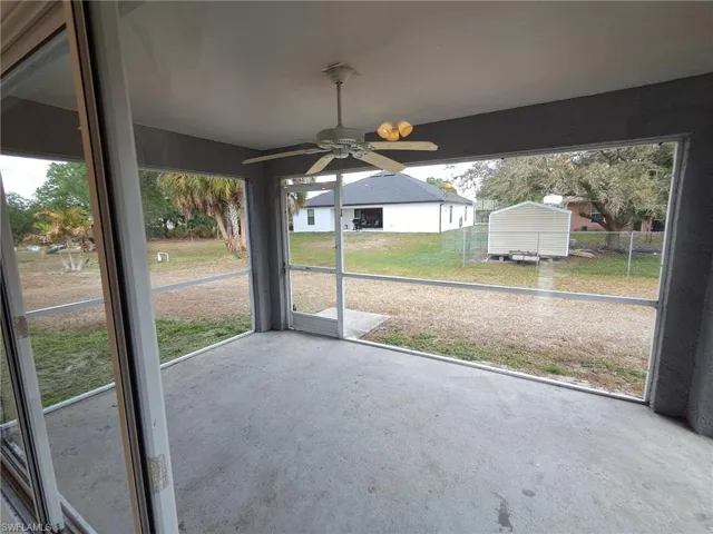 Unfurnished sunroom with ceiling fan and plenty of natural light