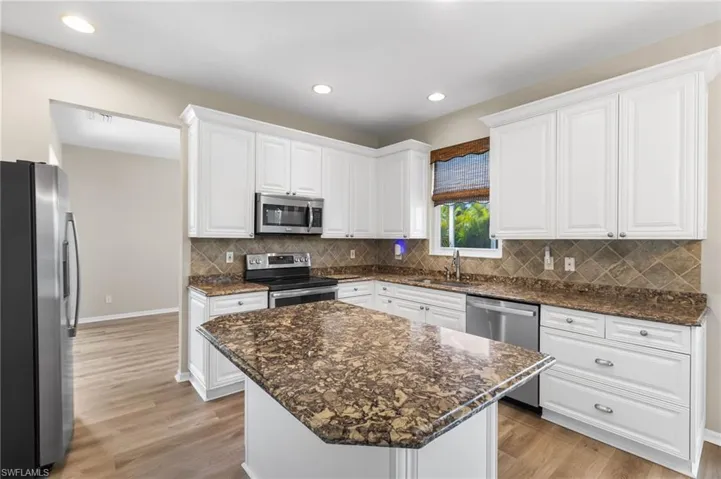 The kitchen is a true centerpiece, showcasing Cambria quartz countertops, 42” cabinetry, stainless steel appliances, a new dishwasher, and a 3-year-old stove—ideal for everyday cooking and hosting family gatherings.