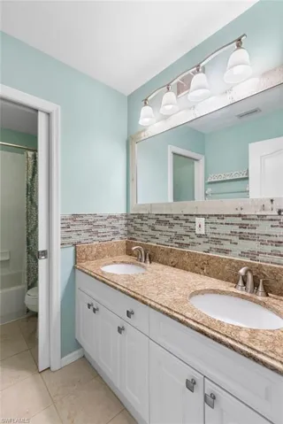 Your second full bathroom features a double vanity, shower / bathtub combination, decorative backsplash, granite countertop. This bathroom is located on the second level.