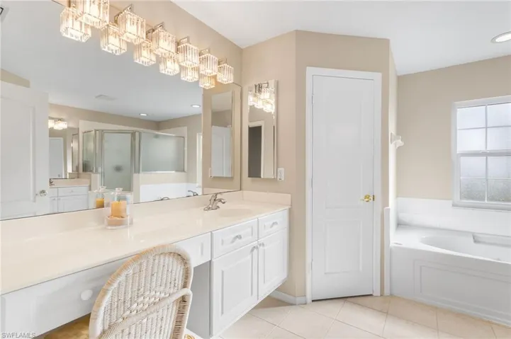 Your spacious primary bathroom offers separate vanities and a dressing area. Garden tub and a separate walk in shower.