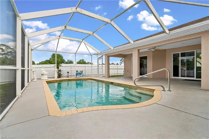 View of swimming pool with a lanai, a sunroom, and patio surround