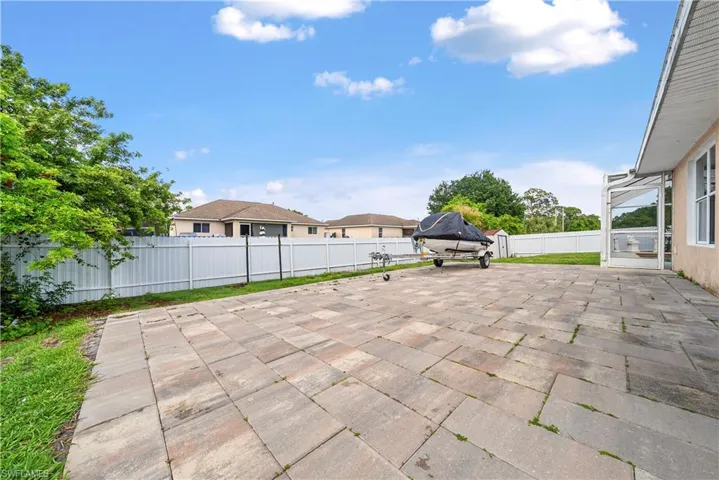 Fenced backyard featuring a patio area and a residential view