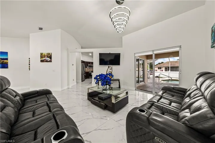 Living area with baseboards and light marble finish flooring