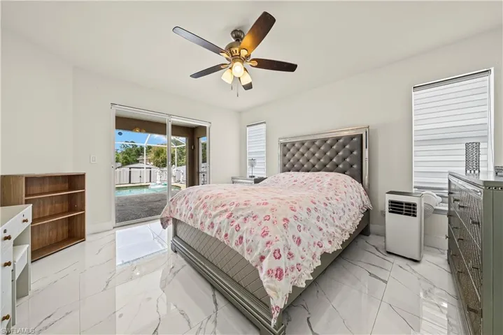 Bedroom featuring access to exterior and a ceiling fan