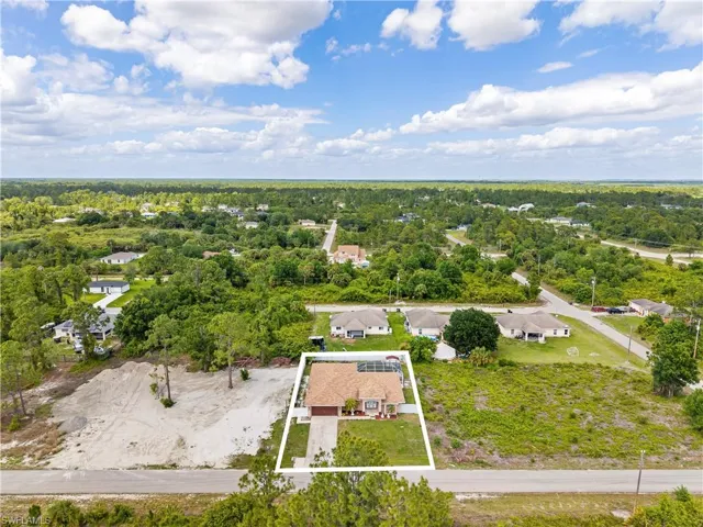 Aerial perspective of suburban area featuring property parcel outlined