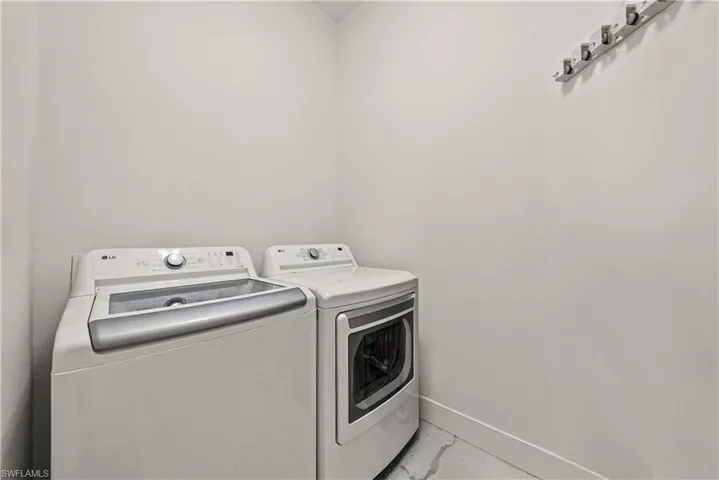 Laundry room featuring baseboards and washer and dryer