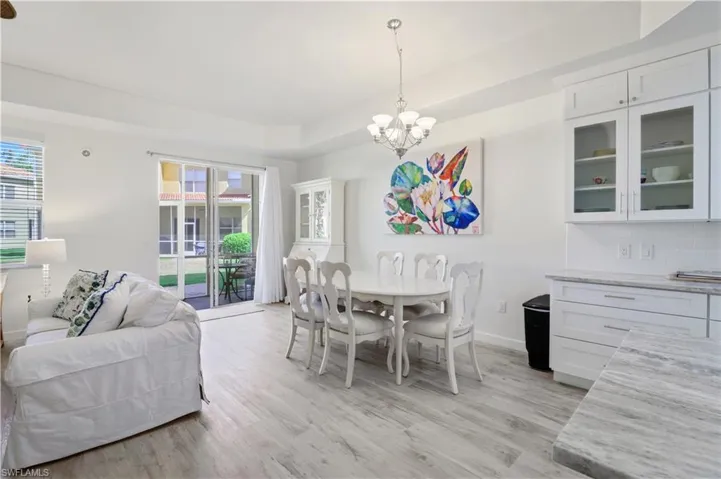 Dining room with an inviting chandelier, baseboards, and light wood finished floors