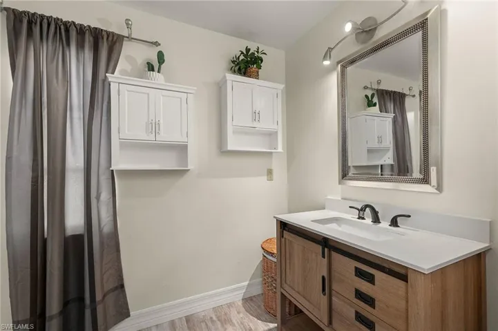 Bathroom featuring hardwood / wood-style flooring and vanity