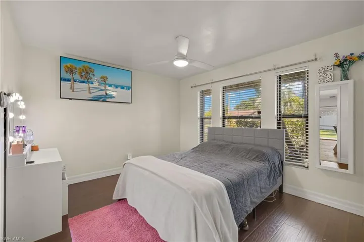 Bedroom featuring dark wood-type flooring and ceiling fan