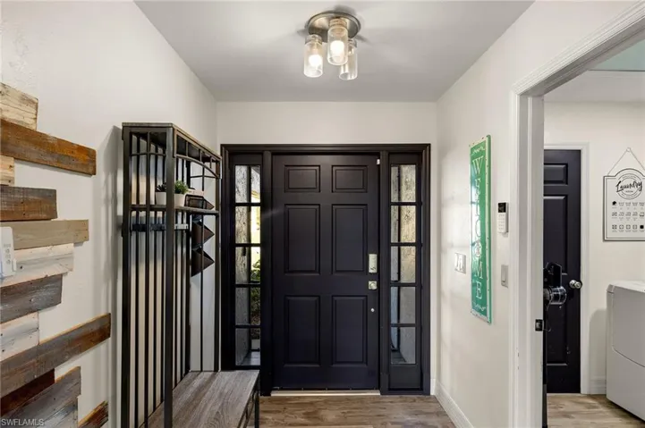 Foyer entrance featuring washer / clothes dryer and light wood-type flooring