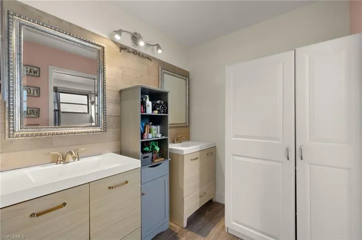 Bathroom featuring tasteful backsplash and vanity