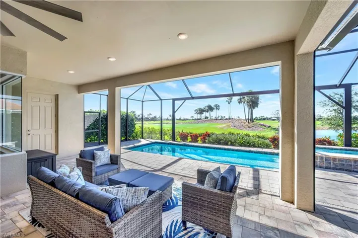 View of pool with ceiling fan, an outdoor hangout area, a patio, and a lanai