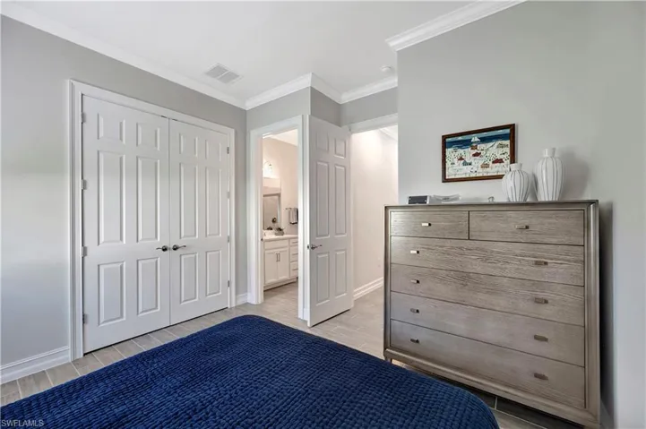 Unfurnished bedroom featuring ornamental molding and a closet