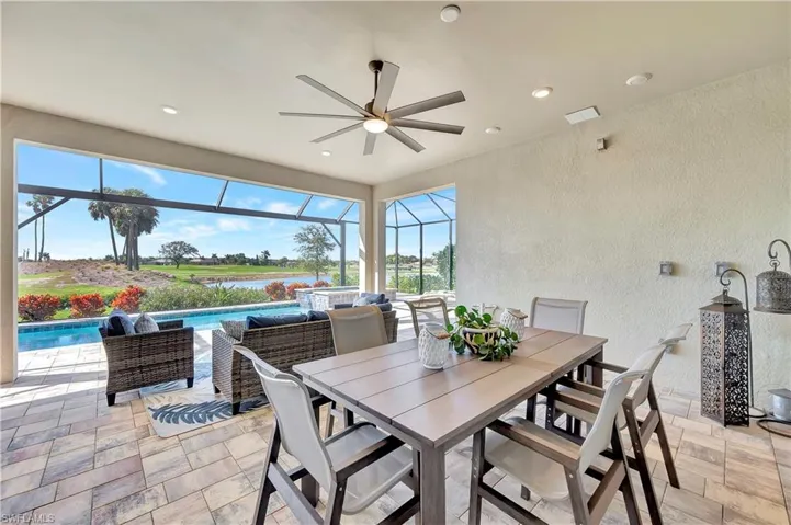 View of patio featuring a water view, ceiling fan, an outdoor living space, and screen enclosure