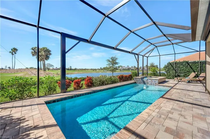 View of swimming pool featuring a water view, an in ground hot tub, a lanai, and a patio