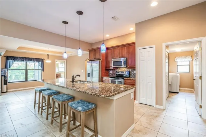 Granite Countertops, Stainless Steel Appliances, Pantry. Looking into Laundry Room.