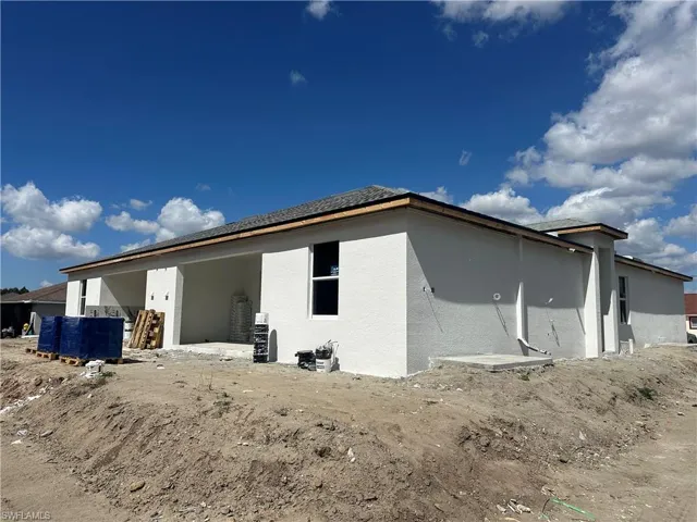 Back of house with stucco siding and a patio area