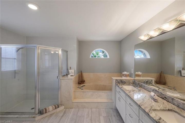 Oversized Primary suite bath with dual sinks garden tub with separate shower