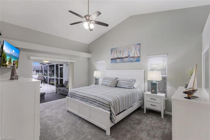 Bright open and spacious the Primary suite with double slider offers a full slide for expanded opening leading to lanai. Notice the new carpet!