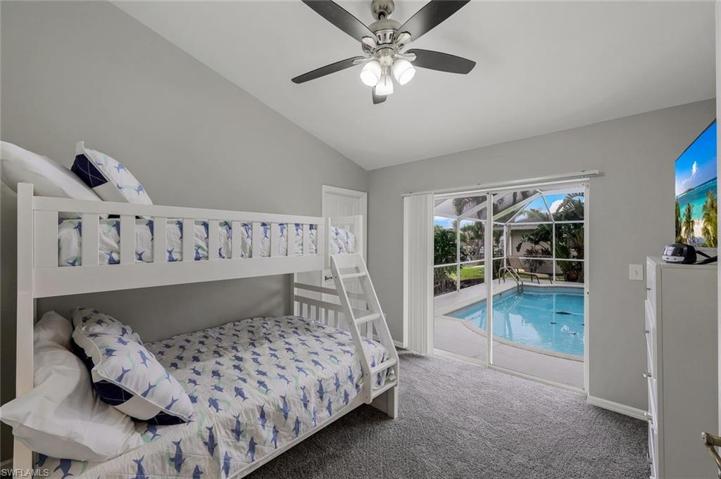 Bedroom #1  full size bed with upper bunk has slider access to pool and dock