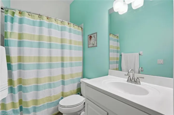Full bath with vanity and a shower with shower curtain