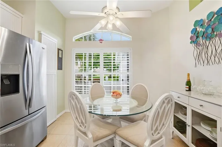 Dining area featuring light tile patterned flooring and a ceiling fan