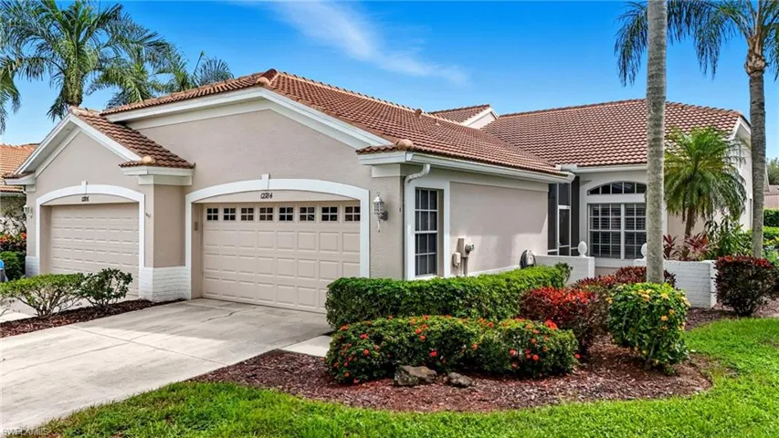 Mediterranean / spanish home featuring stucco siding, concrete driveway, an attached garage, and a tile roof