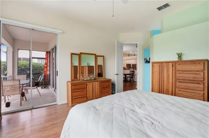 Bedroom featuring wood finished floors, access to outside, and ceiling fan