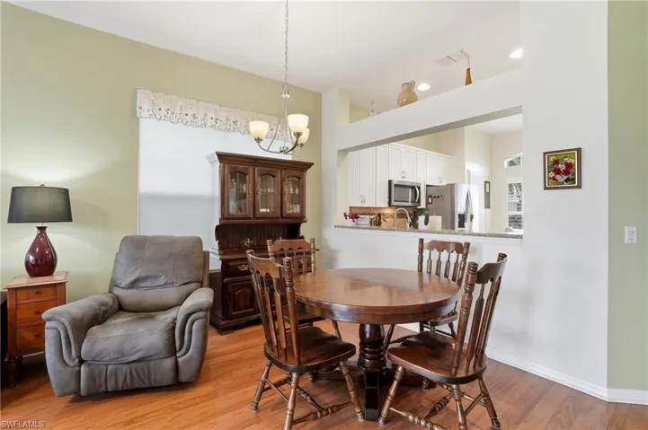 Dining room featuring light wood finished floors and a chandelier