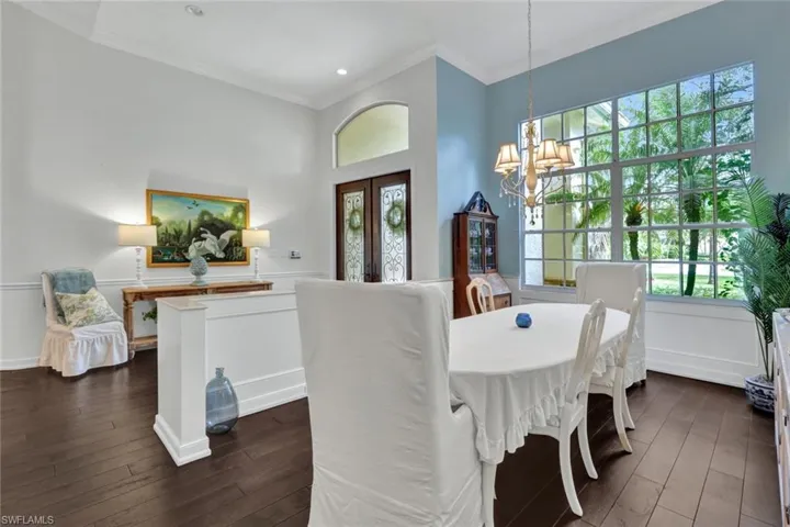 Dining room with a chandelier, french doors, dark hardwood / wood-style flooring, and ornamental molding