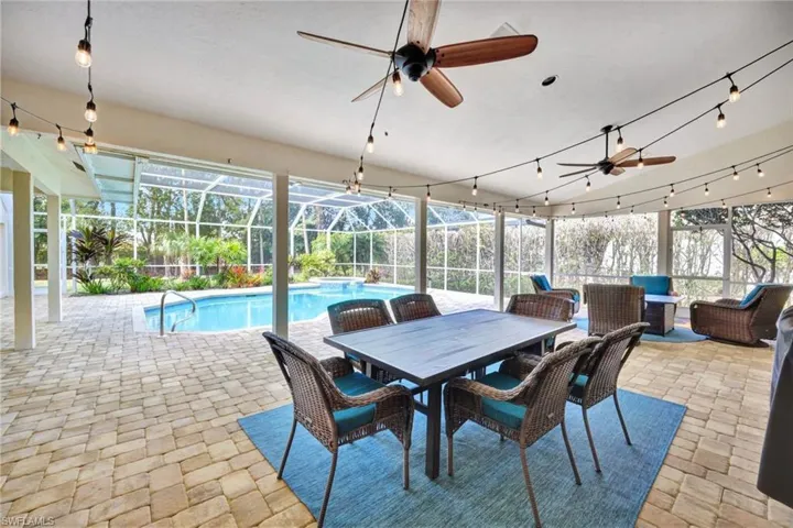 View of pool with ceiling fan