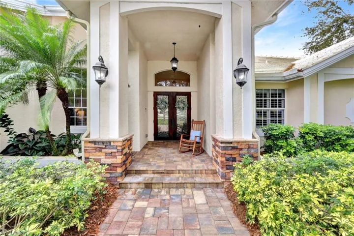 Property entrance featuring french doors and a porch