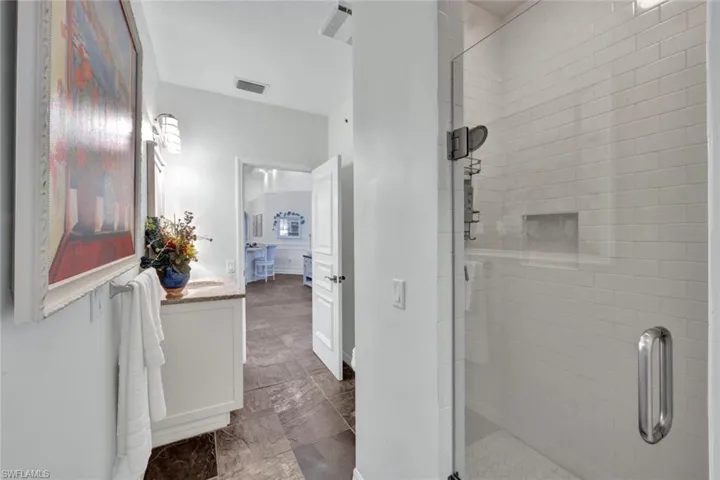 Bathroom featuring walk in shower and vanity