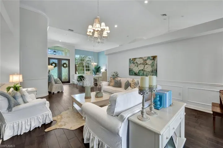 Living room featuring dark hardwood / wood-style floors and a chandelier