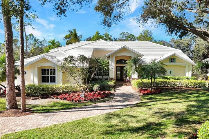 Ranch-style home with a front lawn and french doors