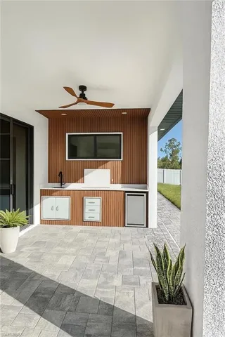 Sitting room with a ceiling fan and wood walls