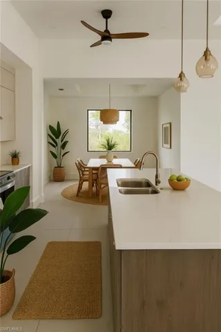Kitchen featuring gray cabinets, modern cabinets, appliances with stainless steel finishes, wall chimney exhaust hood, and light tile patterned floors