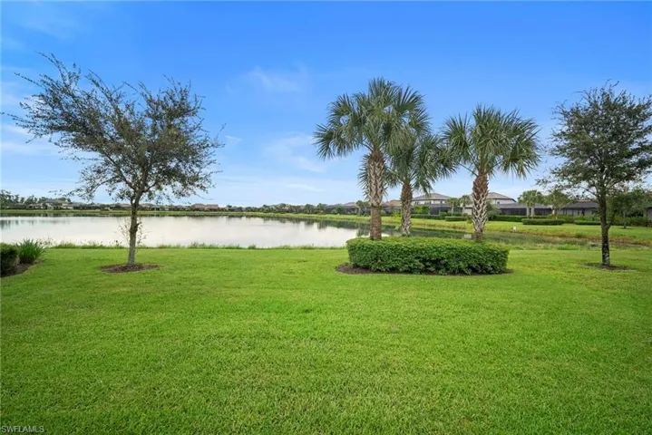 View of green lawn with a water view