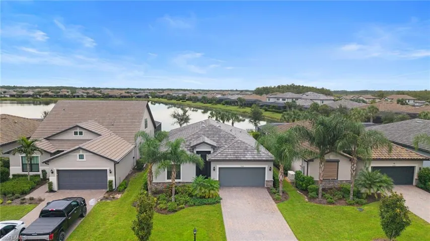 Aerial perspective of suburban area featuring a large body of water