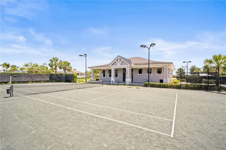 View of tennis court with a porch and community basketball court
