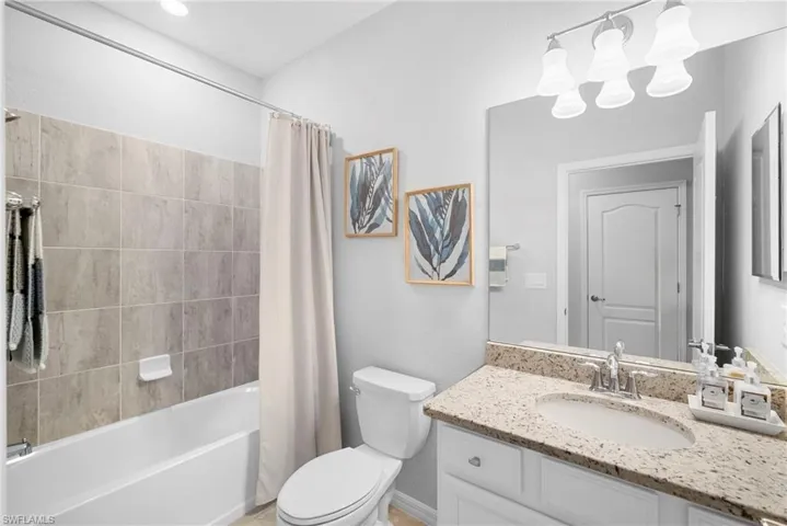 Bathroom featuring shower / bath combo and vanity
