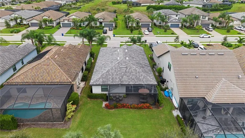 Aerial perspective of suburban area with a pool
