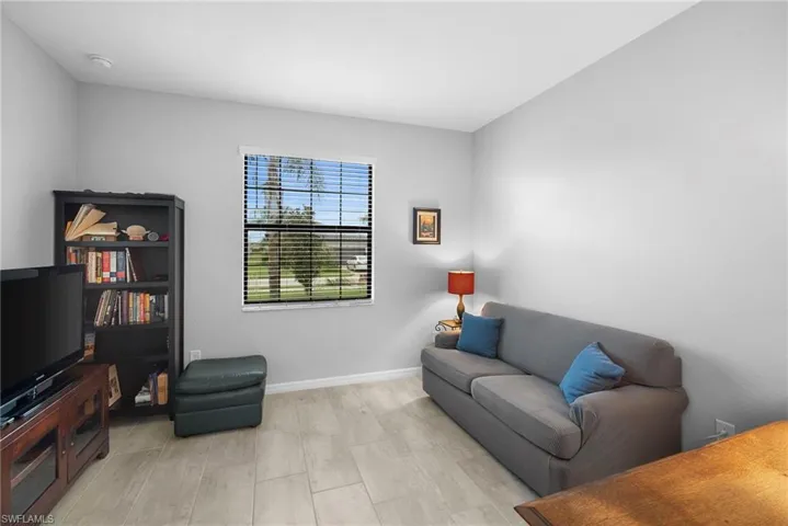 Living area with light wood finished floors and baseboards